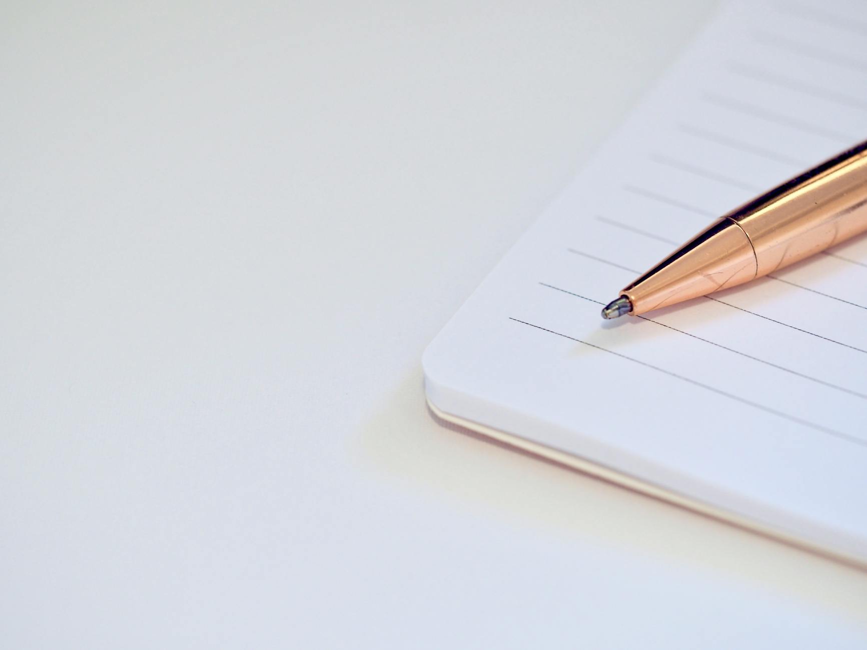 A sleek pen placed on a notebook, symbolizing productivity and planning.